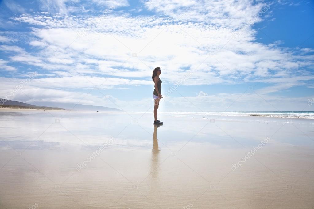white shorts woman standing on seashore