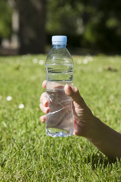 Water plastic bottle in hand — Stock Photo, Image