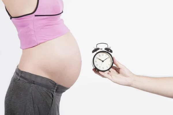 Alarm clock for tummy pregnant — Stock Photo, Image