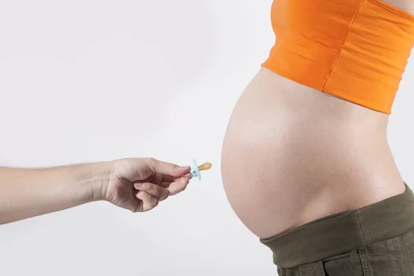 Pacifier for tummy pregnant — Stock Photo, Image