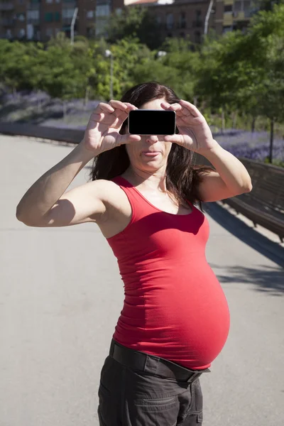 Funny pregnant mobile in face — Stock Photo, Image