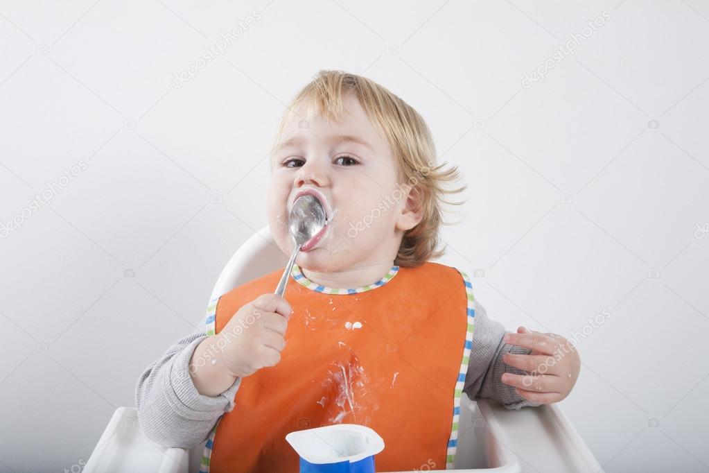 baby licking spoon