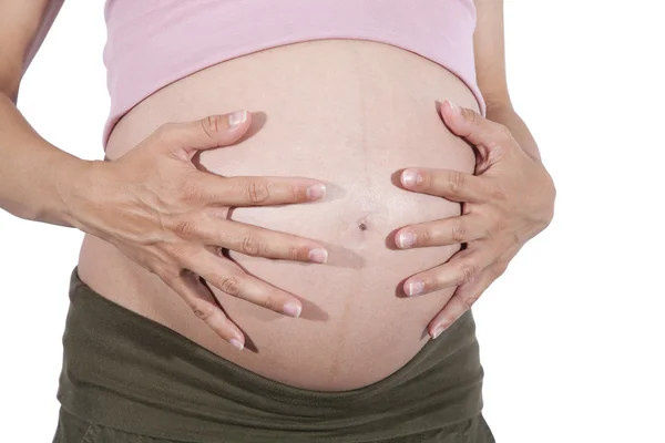 Manos en la barriga embarazada — Foto de Stock