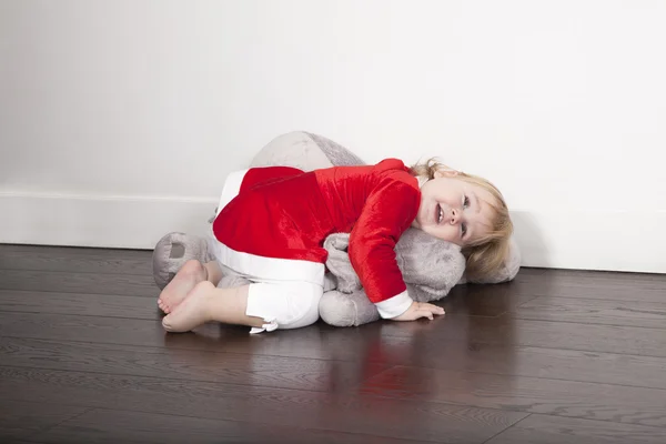 Baby santa claus embraced plush doll — Stock Photo, Image