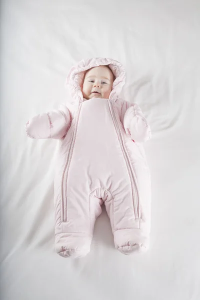 Rózsaszín snowsuit Baba ágy Stock Kép