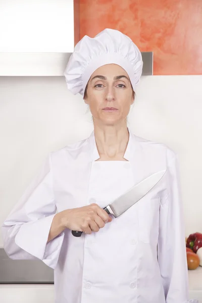 proud woman chef saluting knife on chest