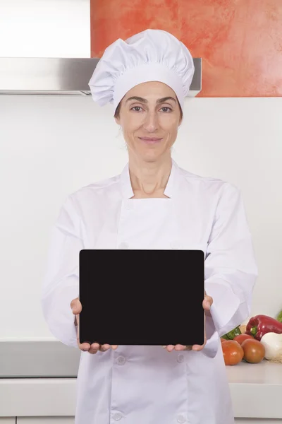 Woman chef showing blank tablet — Stock Photo, Image