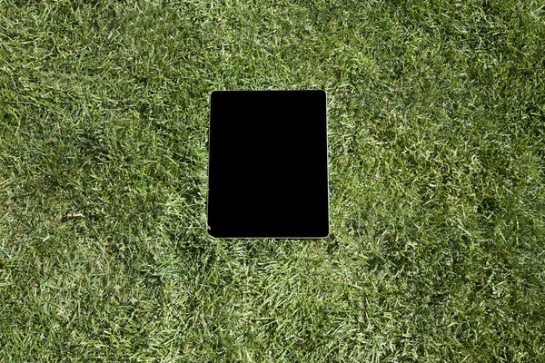 blank screen tablet on grass
