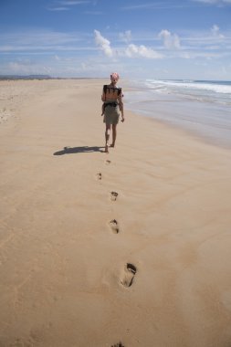woman with baby rucksack at beach