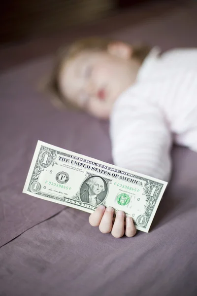Dollar banknote in hand of baby sleeping — Stock Fotó