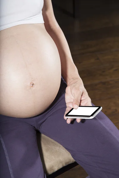 Tummy and smartphone — Stockfoto