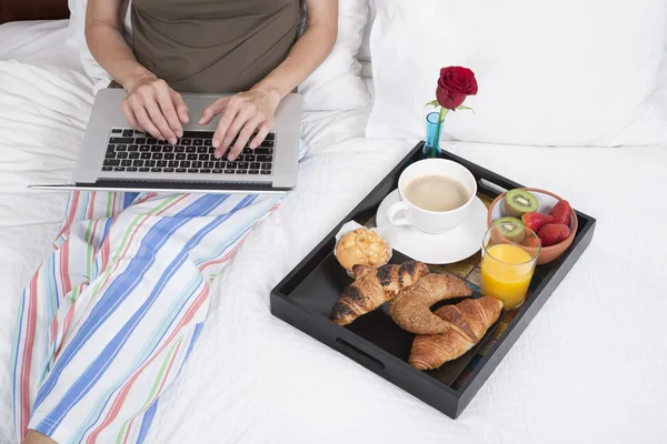 Typing and breakfast on bed — Stok fotoğraf