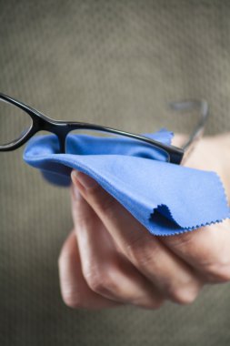 cleaning glasses with blue cloth