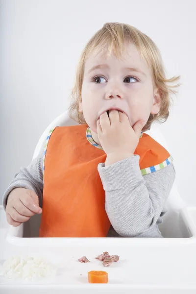 Baby eating hand — Stockfoto