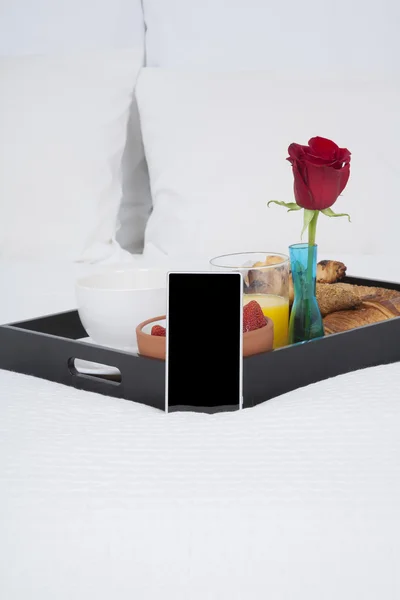 Breakfast and mobile on bed — 스톡 사진