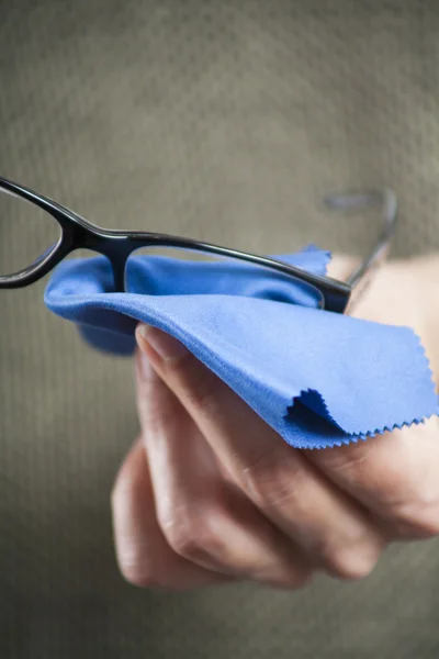 Cleaning glasses with blue cloth — Stok fotoğraf