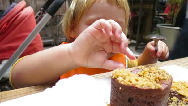 Baby eating chocolate coulant — Stock Video