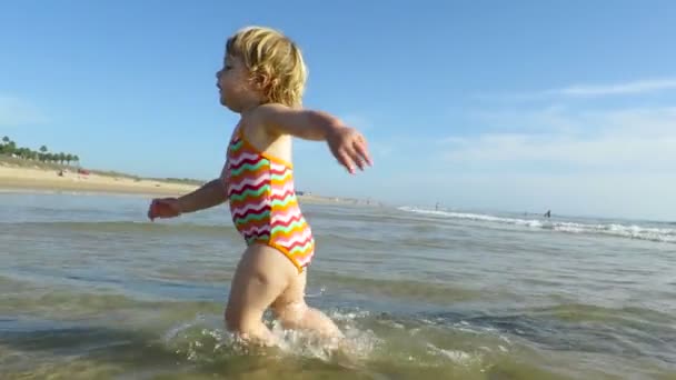 Baby walking in ocean slow motion — Stock Video