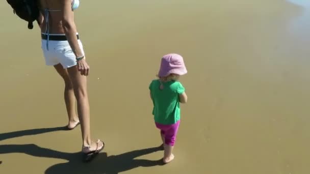 Madre y bebé caminando en la playa — Vídeo de stock