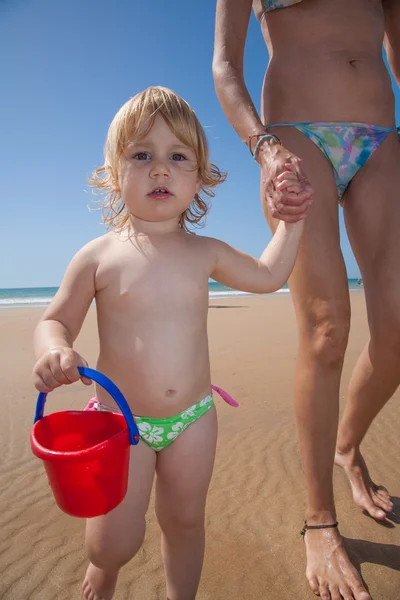 Baby with bucket holding mother — Stock Photo, Image