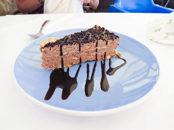 Piece of chocolate cake on blue dish — Stock Photo, Image