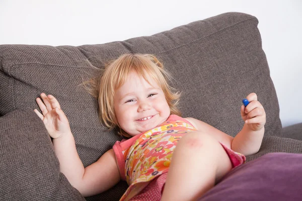 Happy baby on sofa — Stock Photo, Image