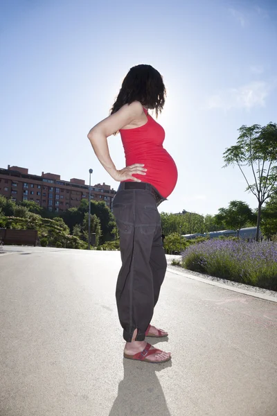 Red pregnant woman side — Stock Photo, Image