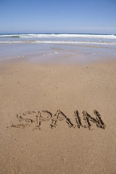 Іспанія, написаний на білопіщаному пляжі — стокове фото