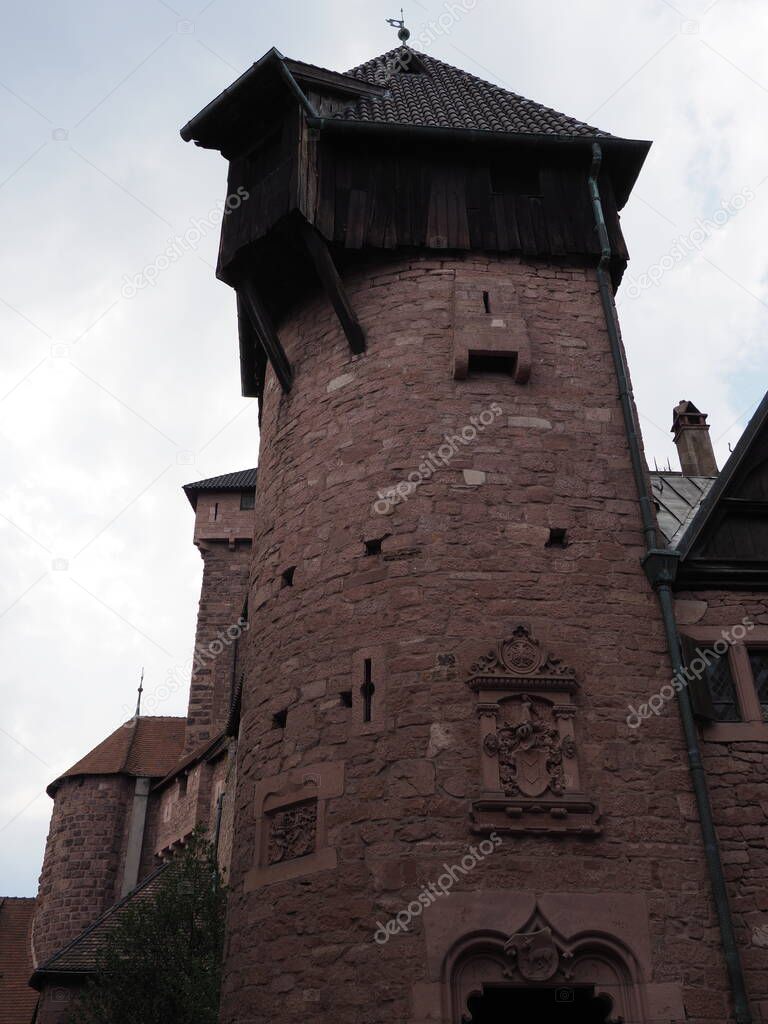 Tower of Koenigsbourg castle in european Orschwiller town of Alsace region in France with cloudy sky in 2018 warm summer day on August - vertical