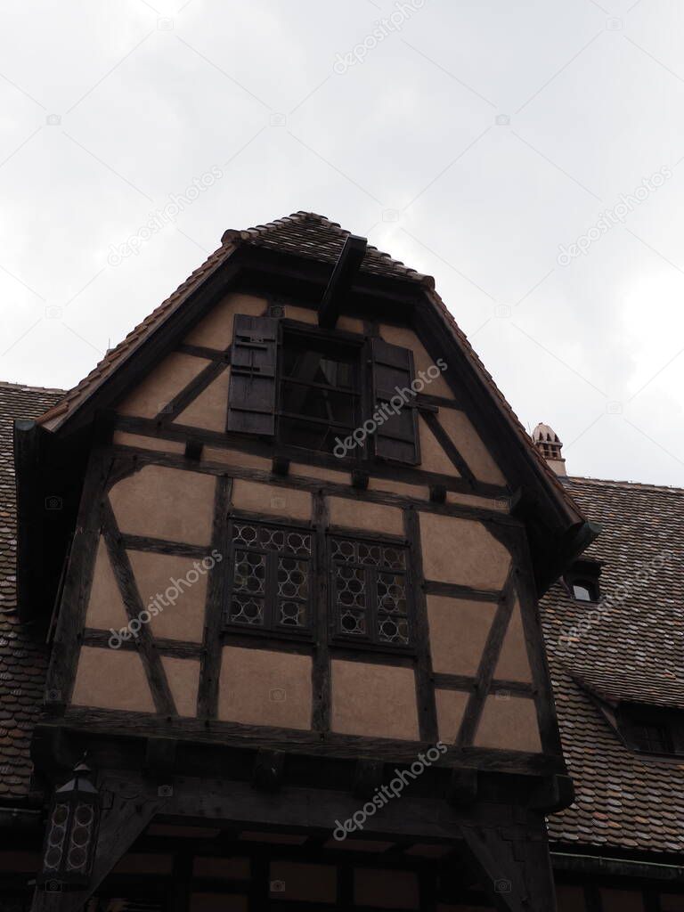 Half-timbered part of Koenigsbourg castle in european Orschwiller town of Alsace in France, blue sky in 2018 warm summer day on August - vertical