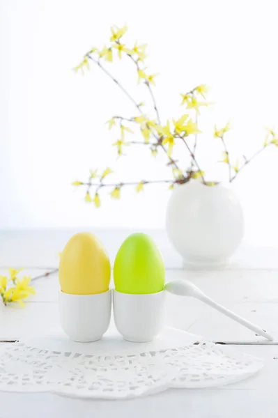 Easter composition with eggs and flowering branches on wooden table — Stock Photo, Image