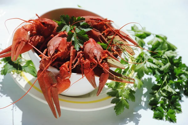 White bowl of boiled crayfish outdoor