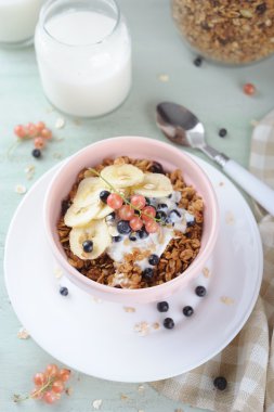 Yoğurt, taze çilek ve muz seramik kase ile bal granola