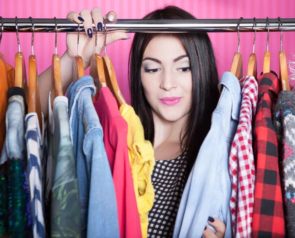 Surprised woman searching for clothing Stock Photo