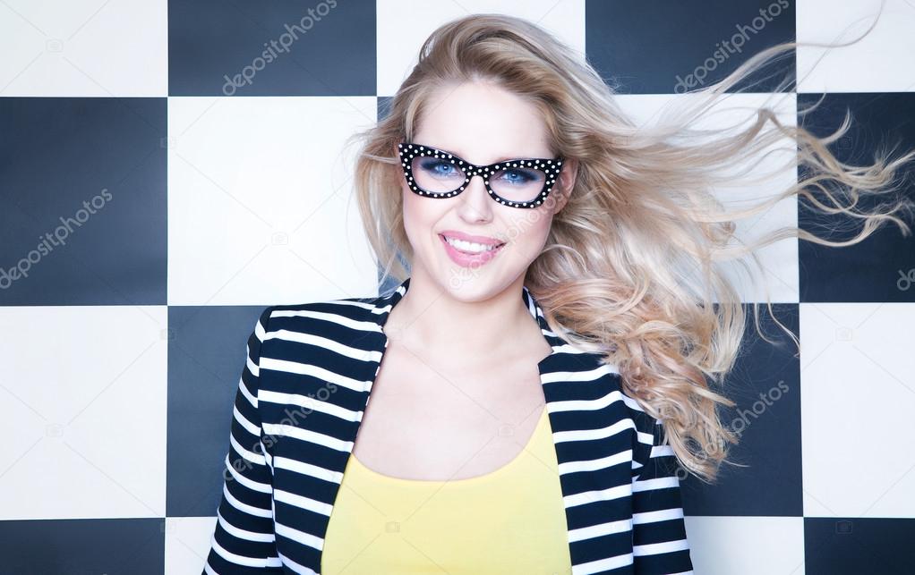 Woman wearing sunglasses on checkered background