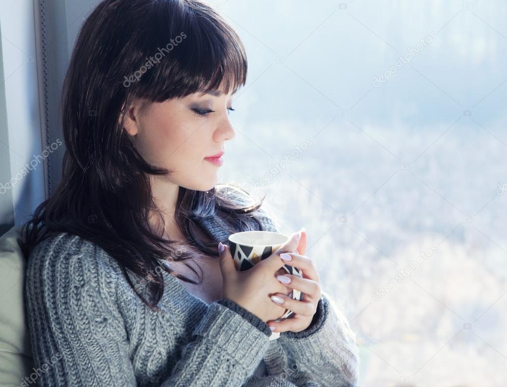 Brunette woman drinking coffee