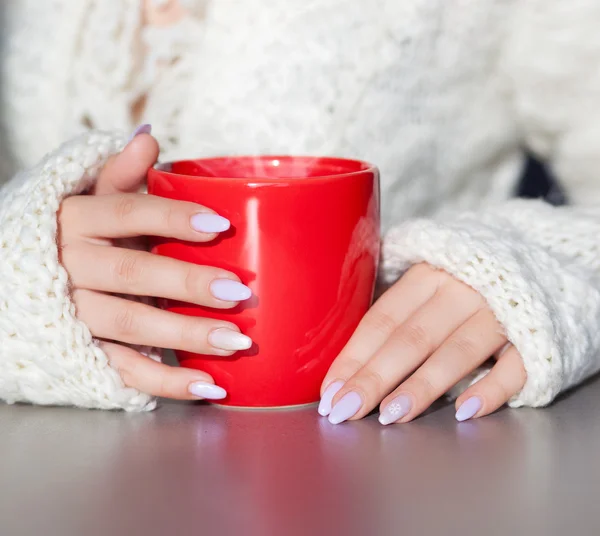 Woman's hands holding cup of hot coffee drink — Stock Photo, Image