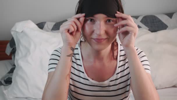 Young Woman Lies Bed Bright Day Woman Puts Sleep Mask — Stock Video