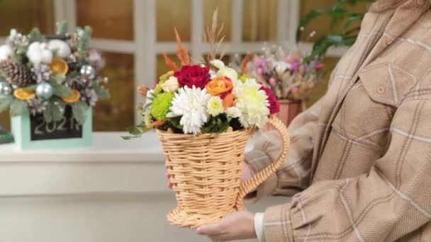 Young woman holding a bouquet with colorful flowers in her hands. — Stock Video