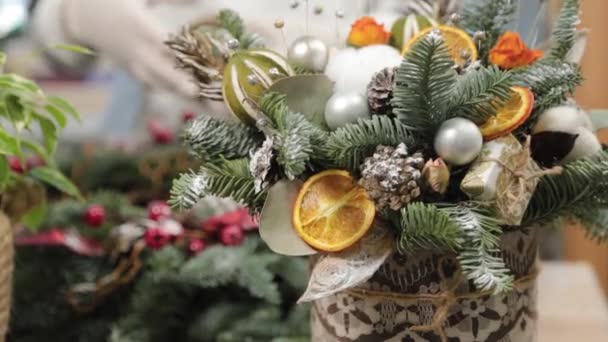 Woman florist makes new year compositions. — Stock Video