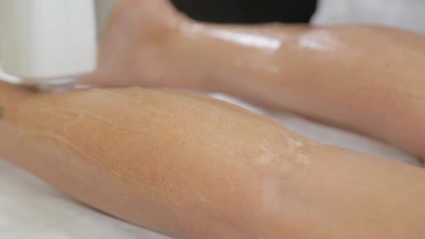 Mulher esteticista faz depilação a laser nas pernas. — Vídeo de Stock