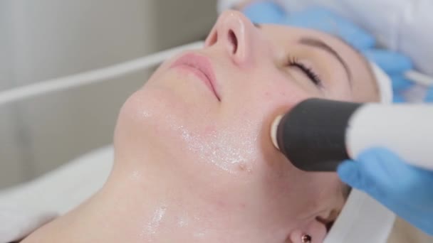 Professionell kosmetolog kvinna som gör karboxyterapi maskin i ansiktet på en kund. — Stockvideo