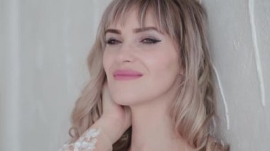 Beyaz odada giyinmiş güzel bir kadın.