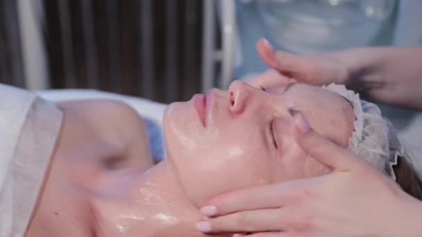 Kadın kozmetik uzmanı kadın yüzüne makyaj kremi sürüyor.. — Stok video