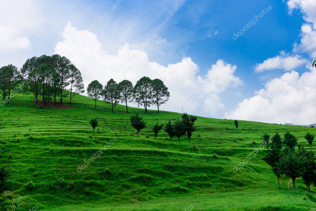 beautiful landscape with green grassy mountains and cloudy sky 