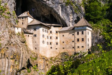 Predjama Castle built in a cave clipart