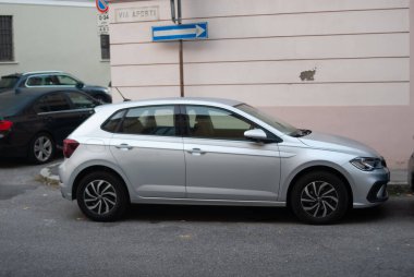 Cremona, İtalya - 2 Ekim 2025 Silver Volkswagen Polo hatchback VİA APORTI, Cenova, İtalya 'da bir cadde boyunca park etmiş ve arka planda konut binaları bulunmaktadır.
