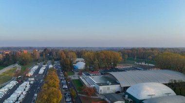 İtalya 'nın Cremona kentindeki Piazzale Azzuri d' Italia park alanını gösteren hava manzarası park halindeki karavan ve karavan dolu.