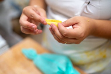 Şefin elleri taze tortelli hazırlıyor. Geleneksel dolgu üzerine sarı makarna hamuru katlıyor. İtalyan mutfak sanatı sergiliyor.