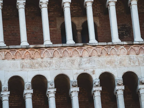 Cremona Katedrali, ortaçağ mimari sanatını vurgulayarak, tarihsel cephesinde ayrıntılı şekillendirilmiş büyük harflerle sıralanmış Romanca kütükler, kemerler ve süslü mermer sütunlar sergiliyor.